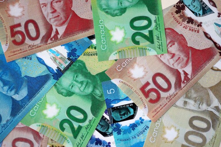 Canadian bills representing finances at risk, illustrating the topic of CRA garnishments and bank account freezes in Canada.