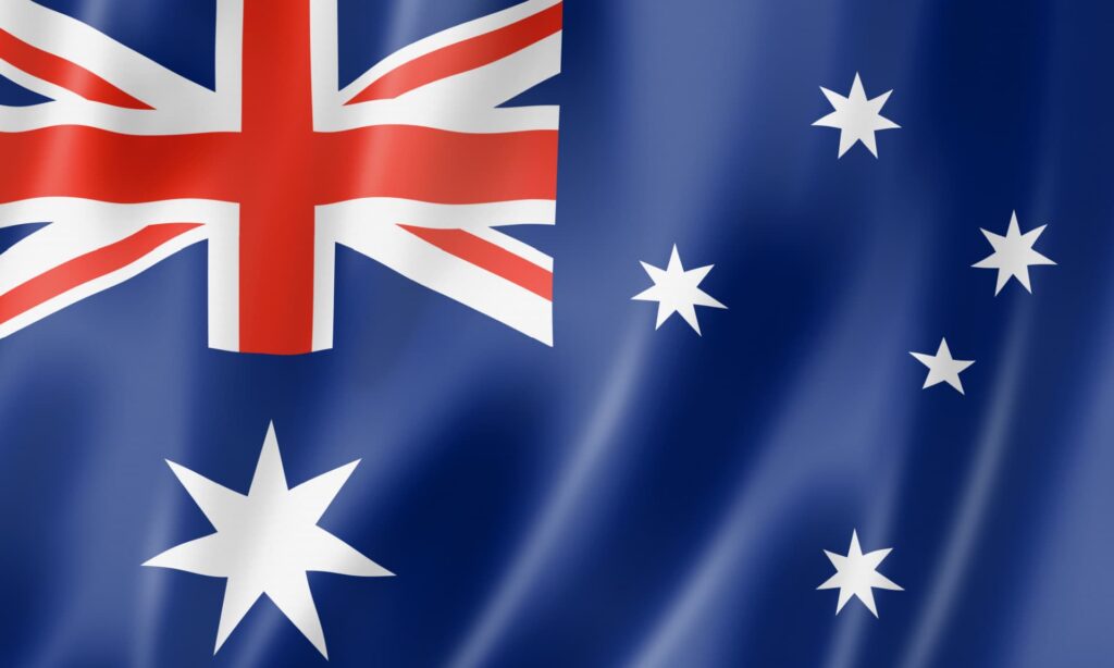 Australian flag, symbolizes comparison in insolvency frameworks Australia versus Canada and lessons learned regarding the risk of unregulated debt consultants