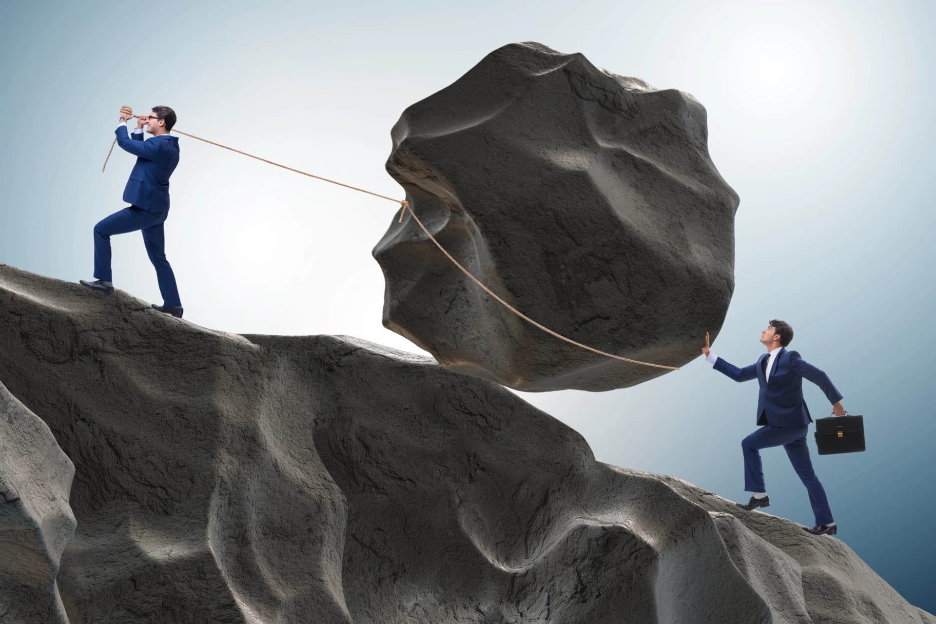 Two professionals pushing a boulder labeled ‘debt’ uphill, symbolizing collaboration between licensed insolvency trustees and other professionals in the management of assertive private lenders and creditor-inspector issues under s.116(2) BIA.