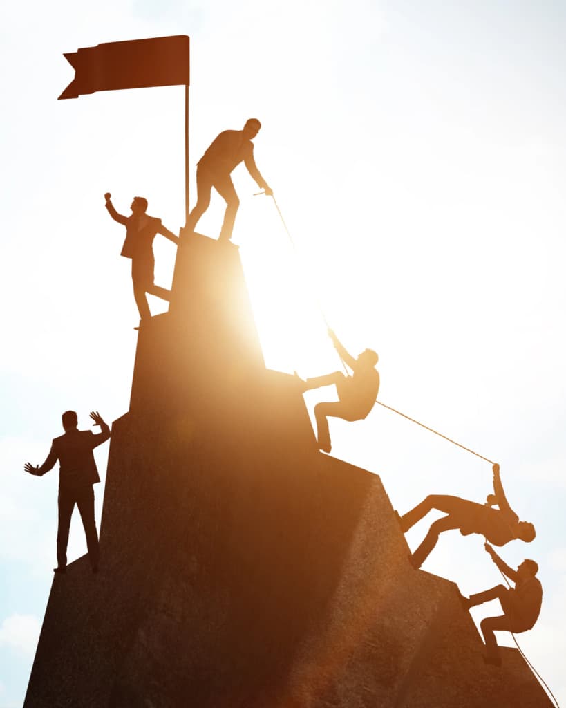 Image of businesspeople climbing mountain together cheering with success, symbolizing professional collaboration between licensed insolvency trustee Paul Franchi and professionals including lawyers, accountants, mortgage brokers and realtors to help guide them in their work with clients under financial stress